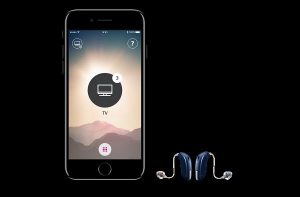 Photo of Oticon mobile app and 2 hearing aids