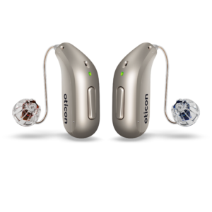 A pair of champagne coloured hearing aids 